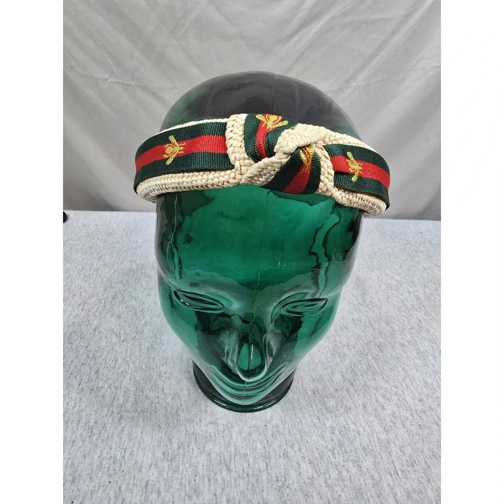 Bee Headband woven straw top-knot headband featuring a red and green striped...